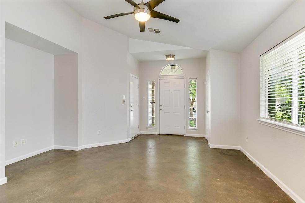 Entryway featuring concrete floors, a ceiling fan