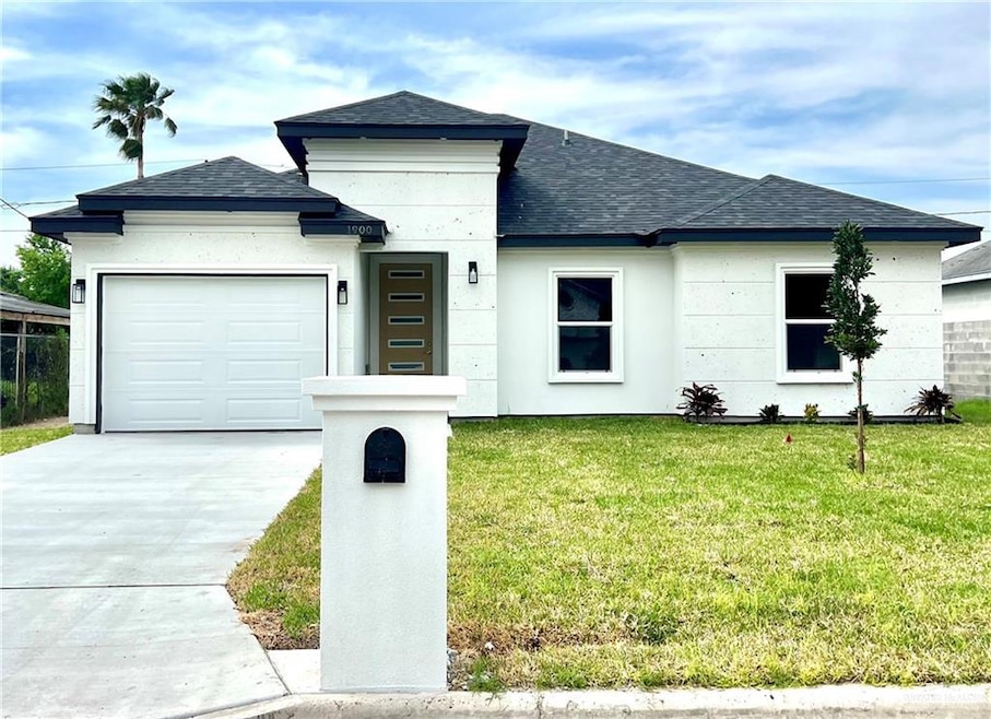 View of front facade with a front yard and a garage