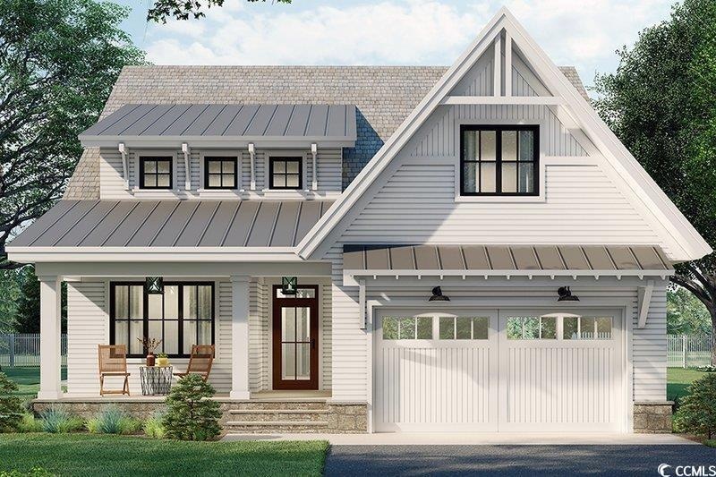 View of front facade featuring a standing seam roof, a porch, metal roof, and an attached garage