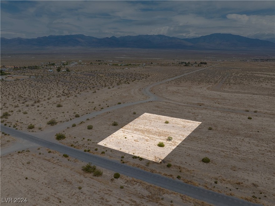Aerial view featuring view of desert, a rural view