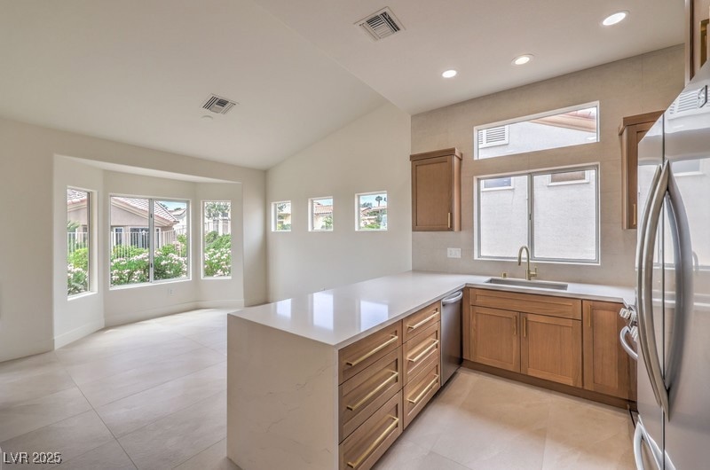 Kitchen with stainless steel appliances, a sink, a
