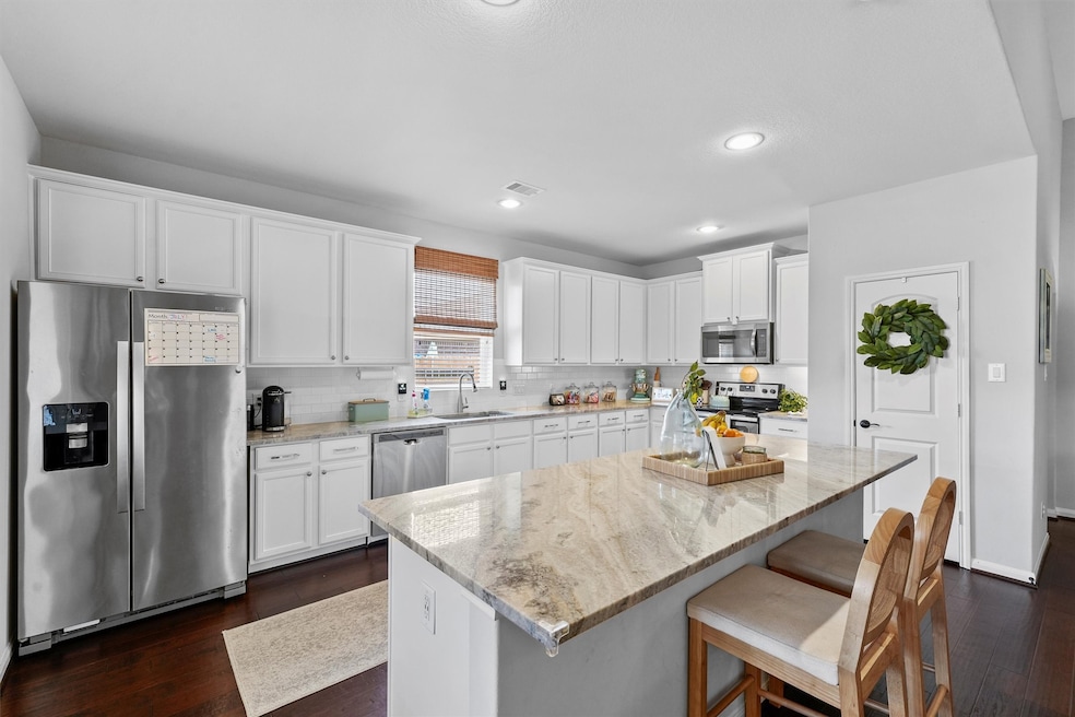 Remodeled kitchen with large island and quartz cou
