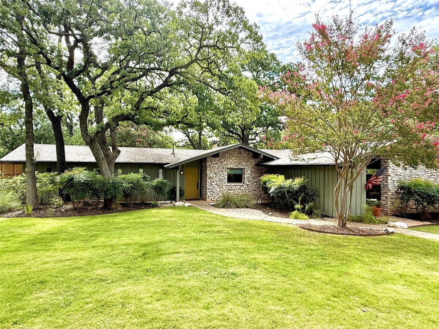 View of front of property with stone siding, a fr