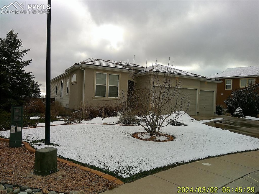 View of front of home with tile roof and stucco si