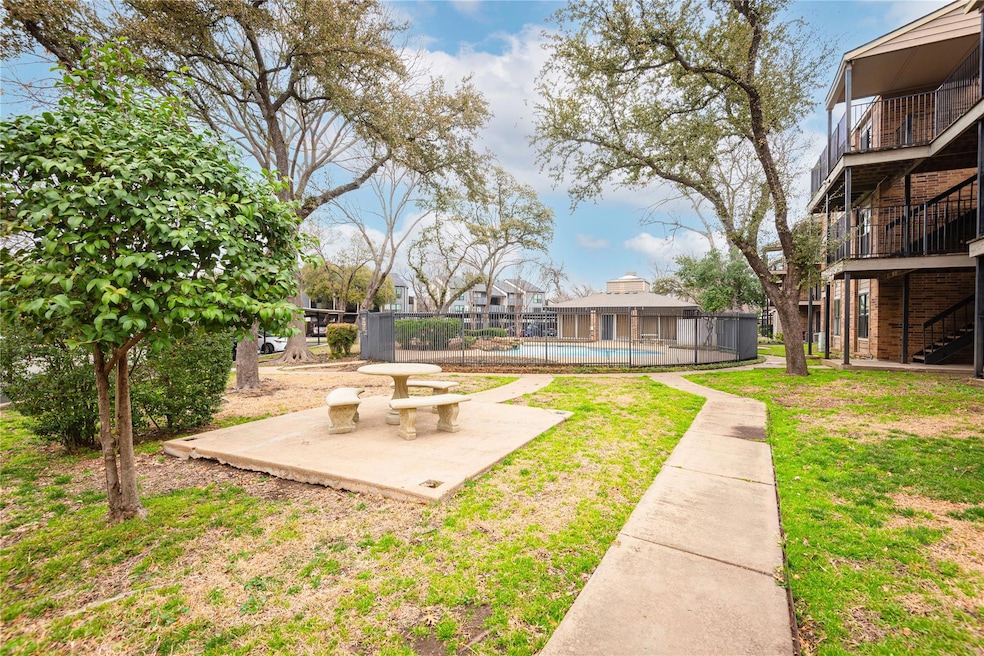 View of yard featuring a balcony, a patio, fence, 