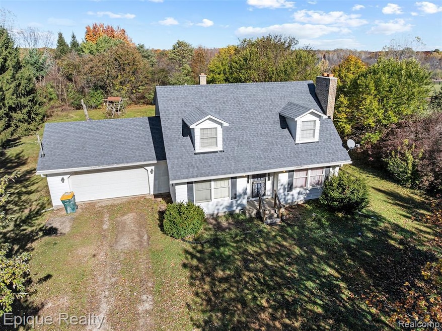 Cape cod home with driveway, a chimney, roof with shingles, and a front yard
