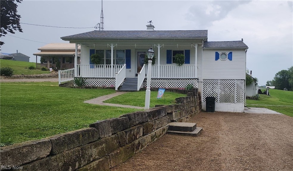 View of front facade with a front lawn and a porch