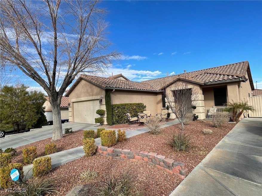 Ranch-style house featuring a tiled roof, stucco s