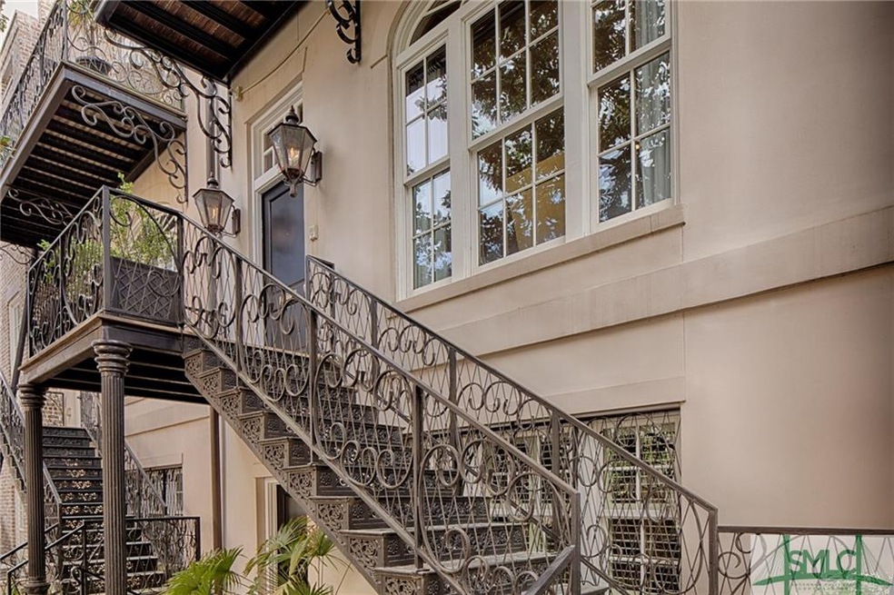 Beautiful wrought iron leads to the front door wit