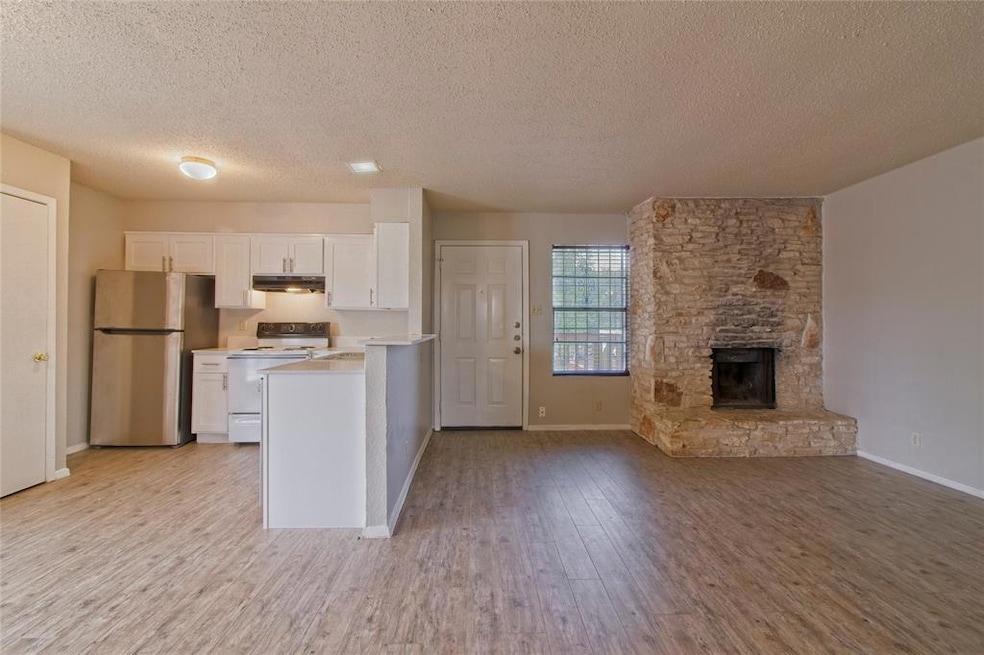 Kitchen featuring white cabinetry, freestanding r
