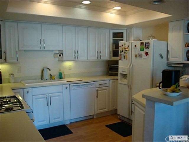 Kitchen with Euro white cabinets with custom pull 