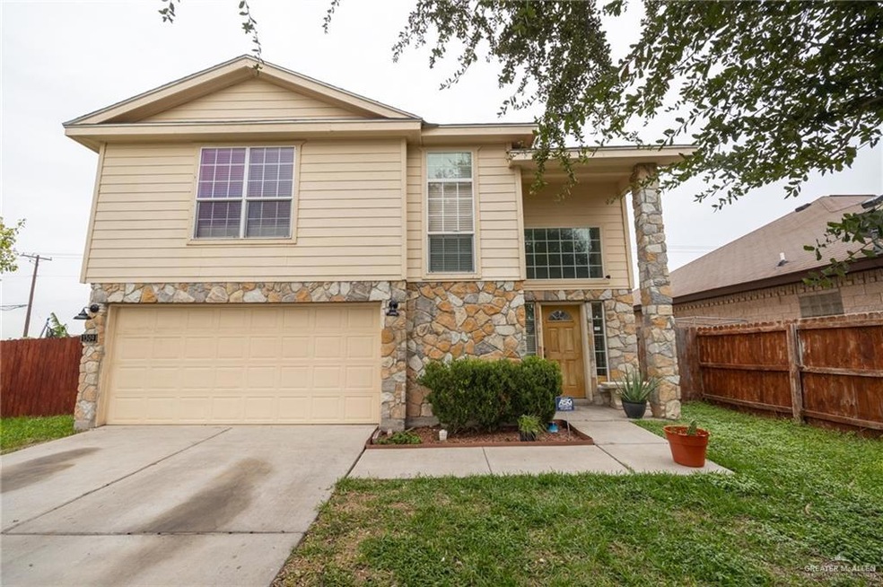 View of front facade with a garage and a front lawn