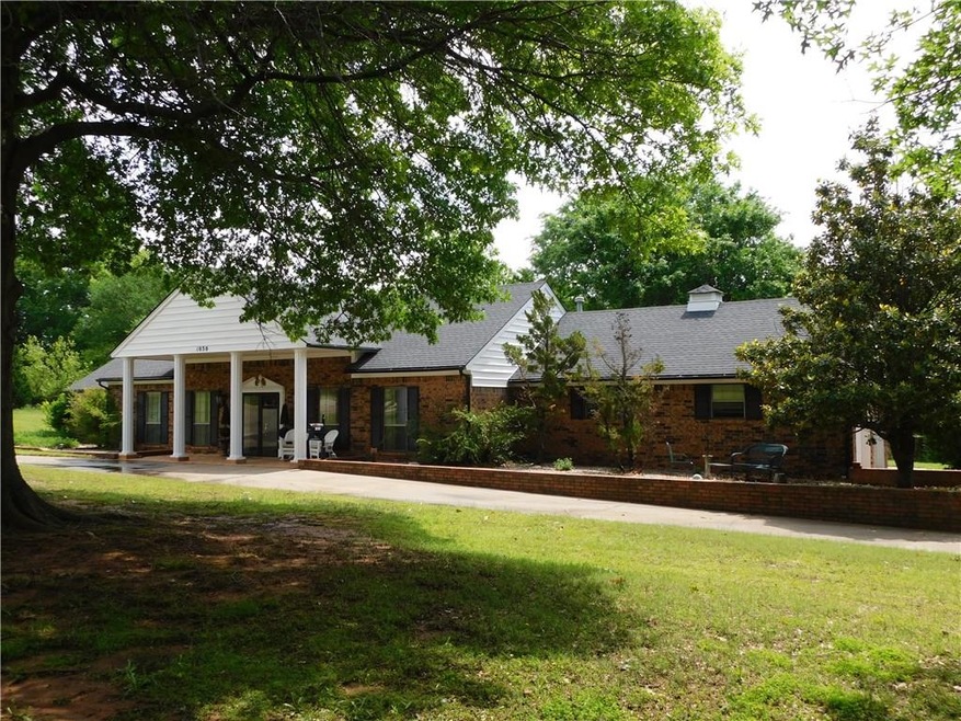 Stately home with beautiful trees, lush yards and 