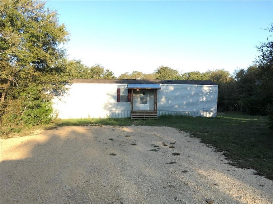 Manufactured / mobile home with gravel driveway