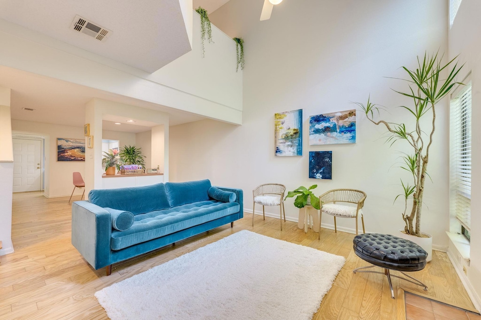 Living area with baseboards and wood finished flo