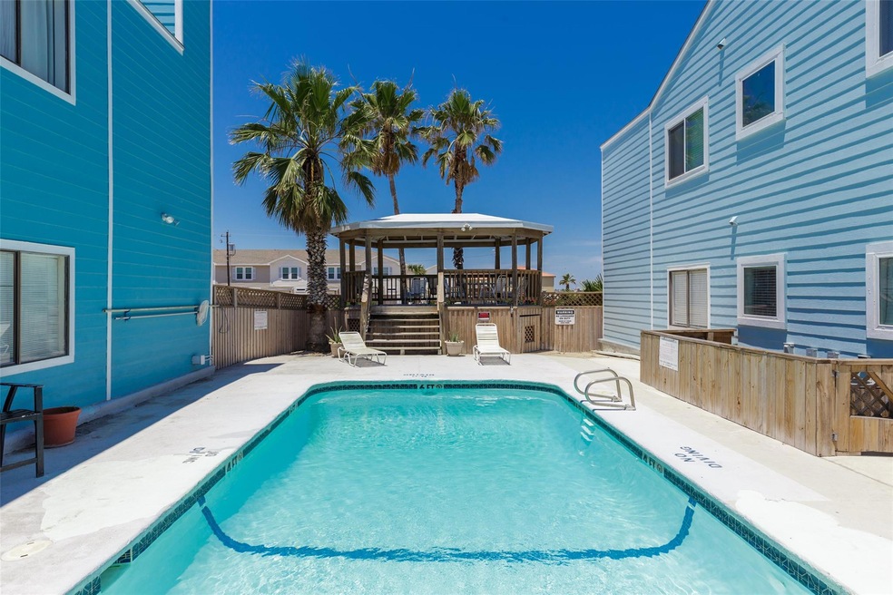 Community pool featuring outdoor dry bar, fence, 