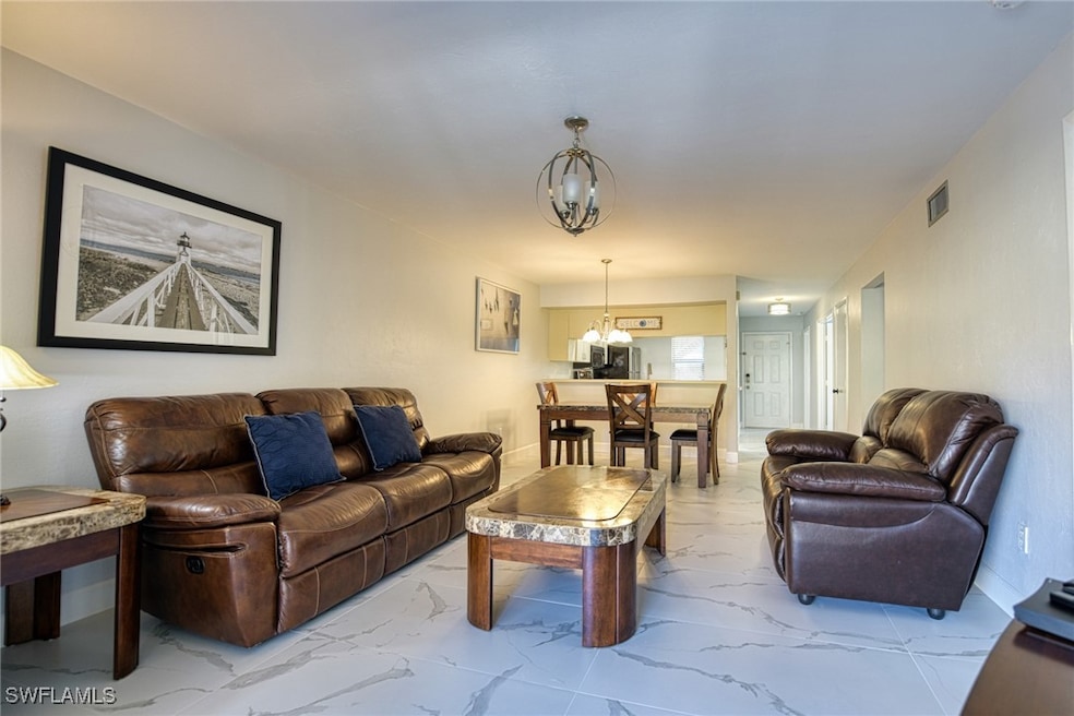 Living area featuring marble finish floors and a c