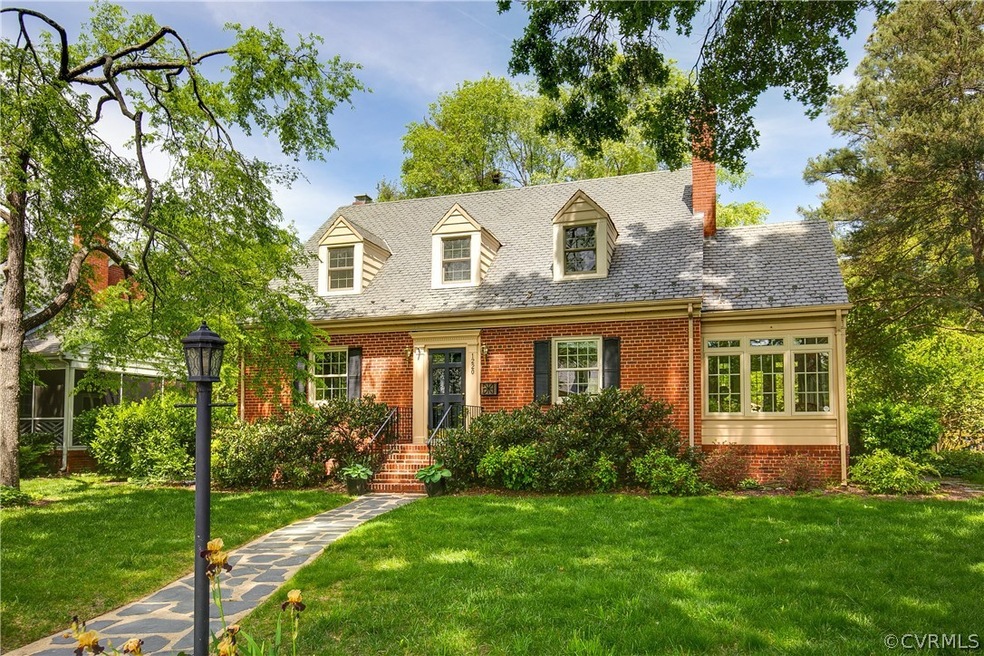 Cape cod home featuring a front lawn