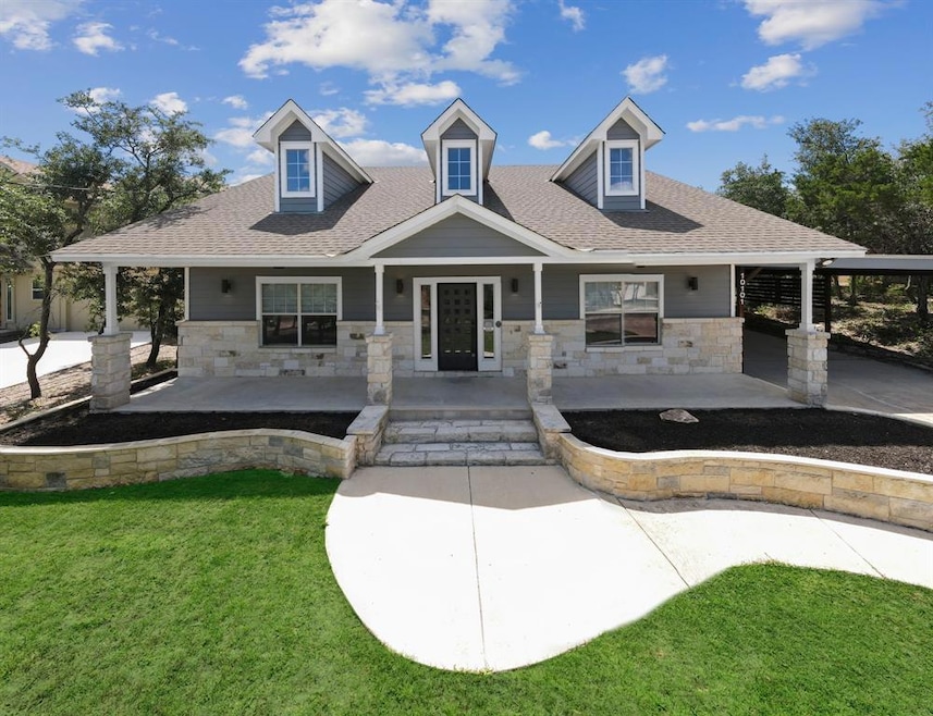 View of front of property featuring stone siding,
