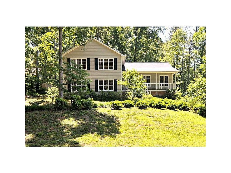Exterior Front. COVERED FRONT PORCH ON WOODED LOT