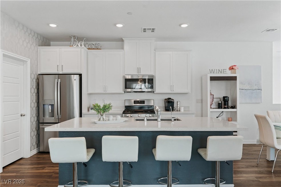 Kitchen with stainless steel appliances, a sink, w