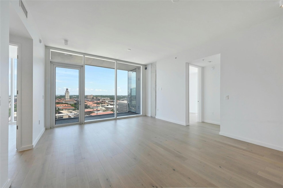 Empty room with visible vents, light wood-type fl