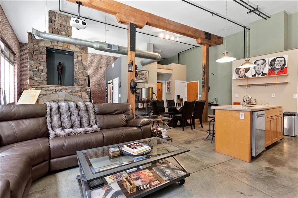 Living area featuring beam ceiling, visible vents,