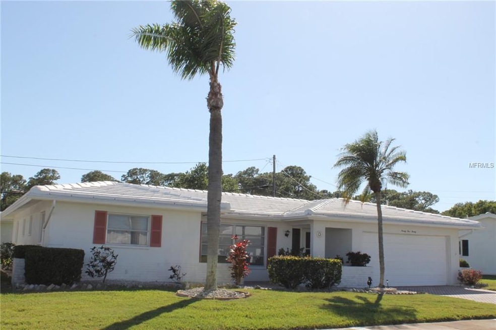 Front of Beautifully Manicured Home with a Pavered