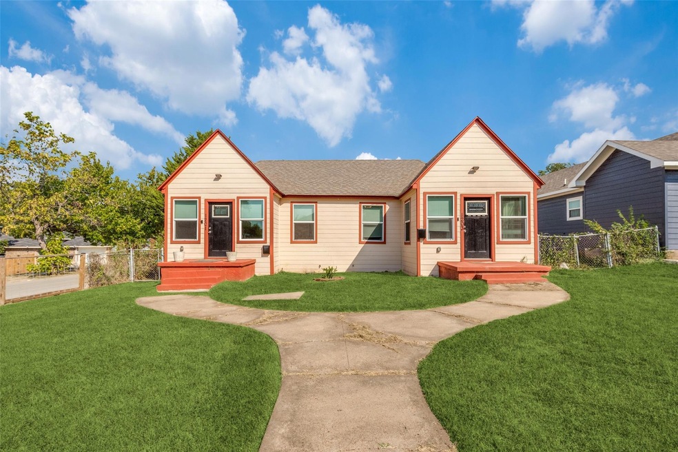 View of front of house with a front yard and circu