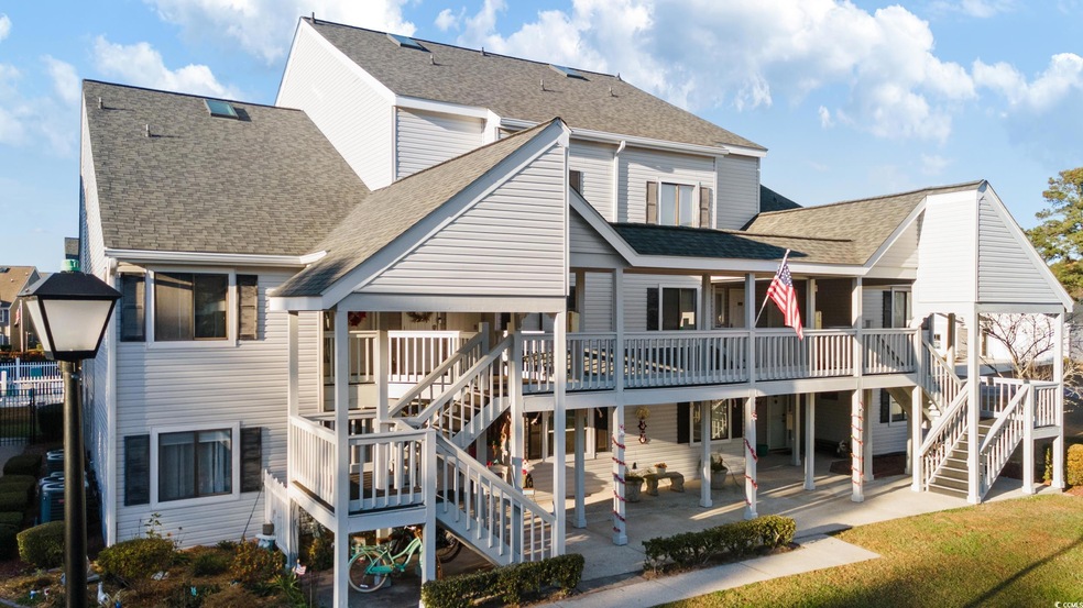 Back of property featuring a yard, a patio, and a 