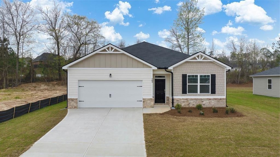 Craftsman-style home with a front yard and a garag