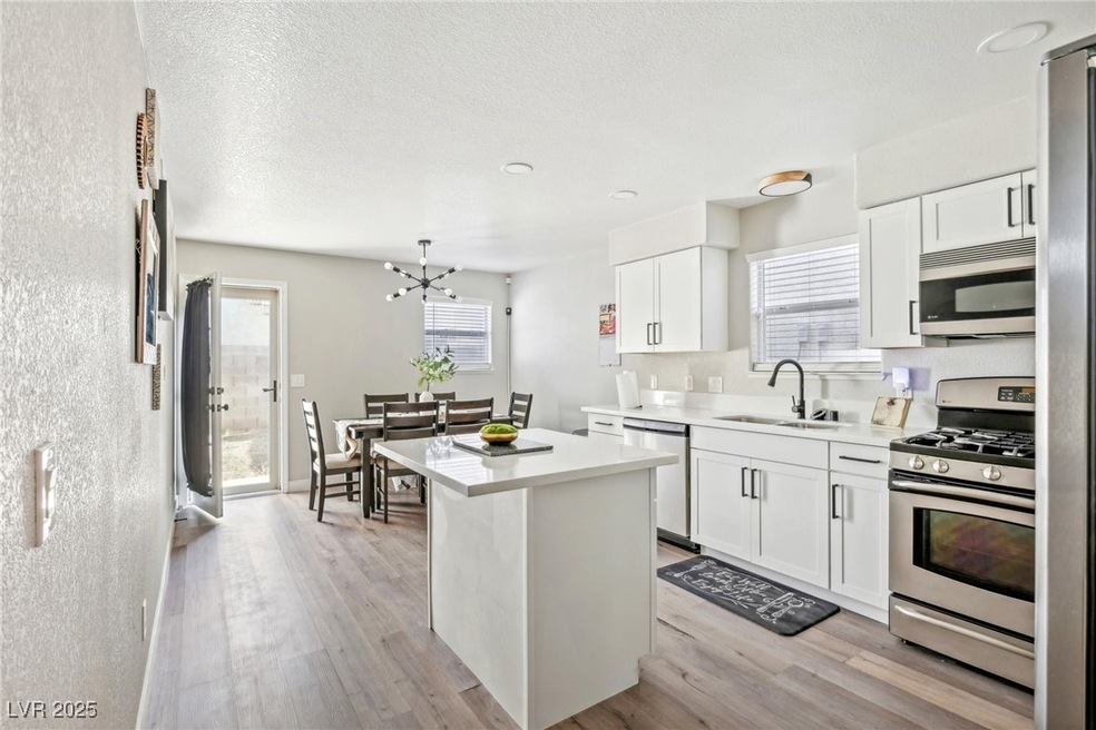 Kitchen featuring UPGRADED quartz countertops, sta