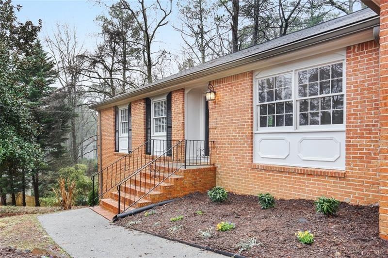Four sided brick, freshly painted trim, gutters in