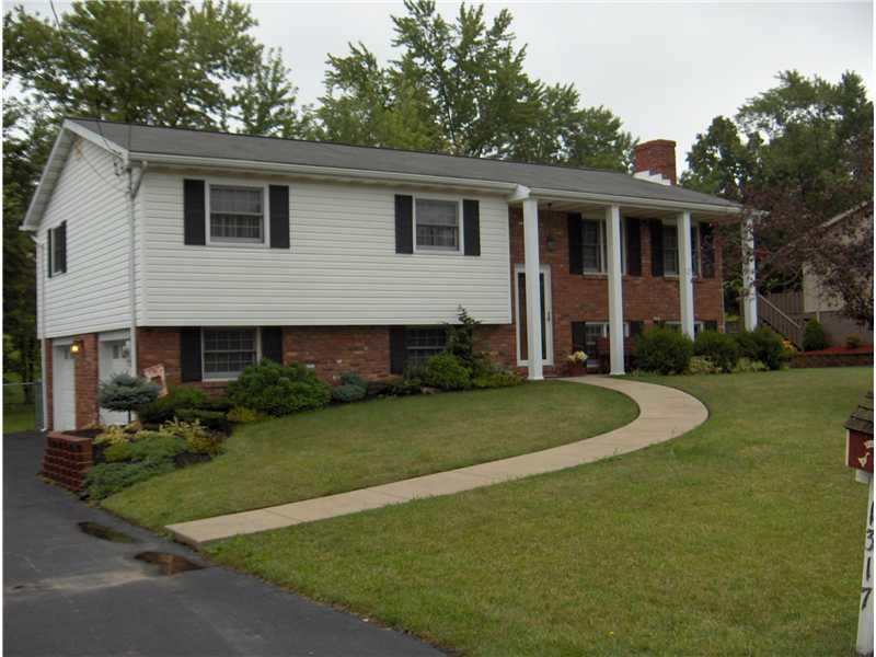 Exterior Front. Brick and vinyl oversized split en