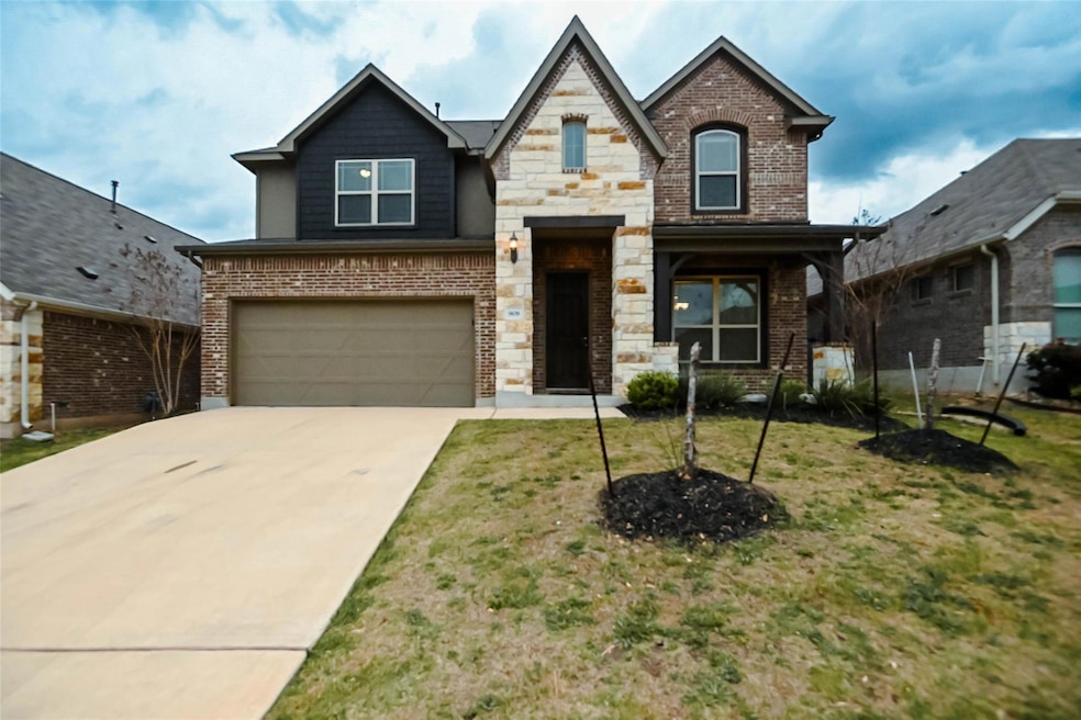 View of front facade featuring concrete driveway,
