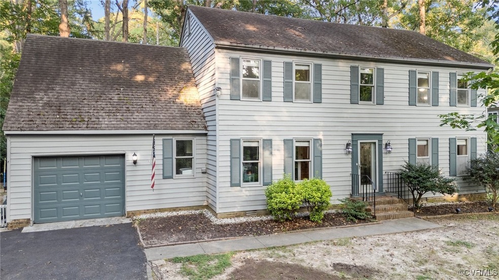 Colonial-style house featuring a garage