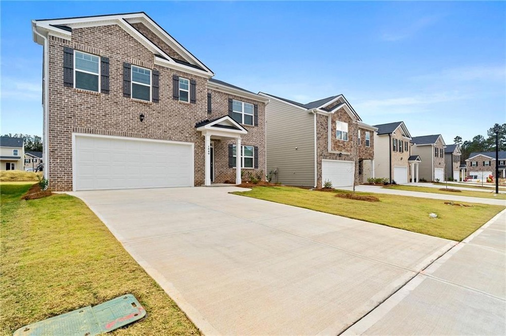 View of front of house with a front lawn and a garage