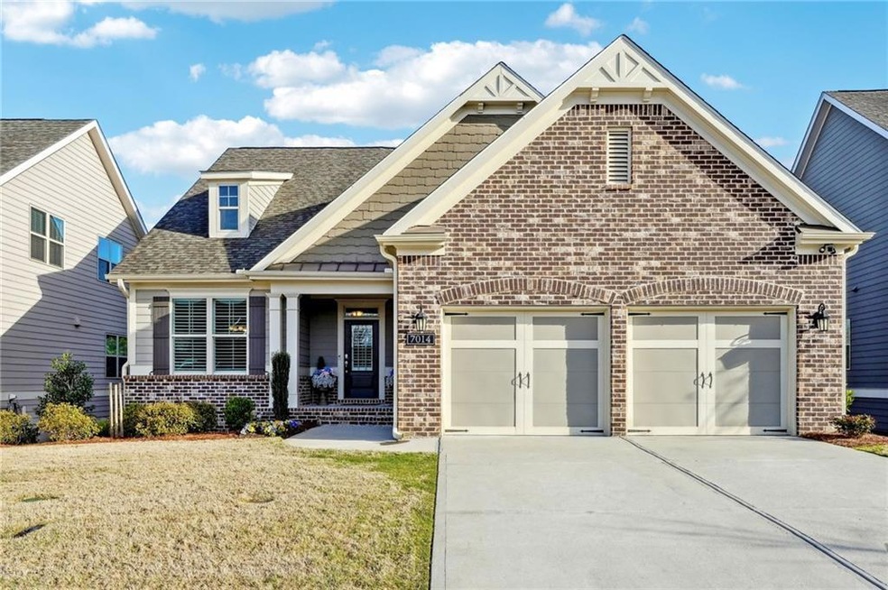 View of front of house with a garage and a front y