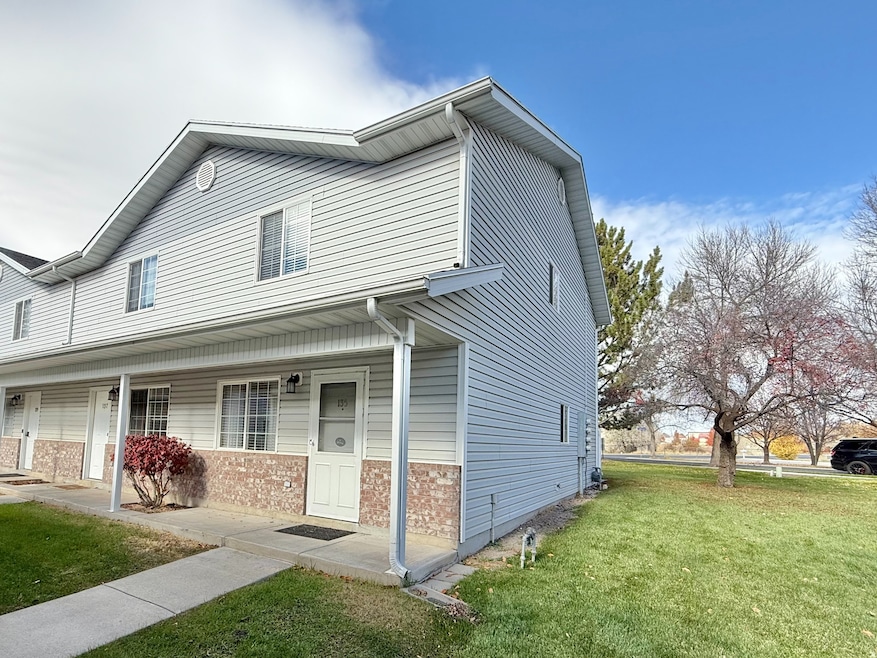 View of front of house featuring a porch, a front yard, and brick siding