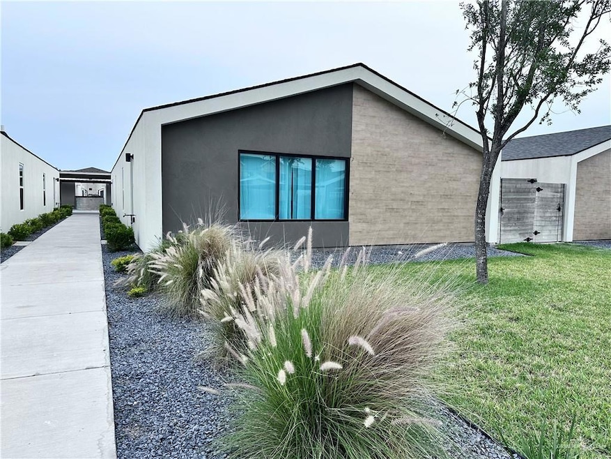 View of home's exterior with a lawn and stucco siding