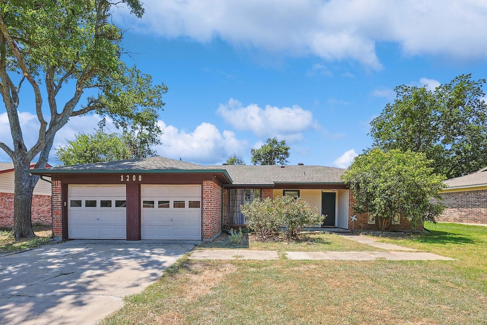 View of front of house with a garage and a front y