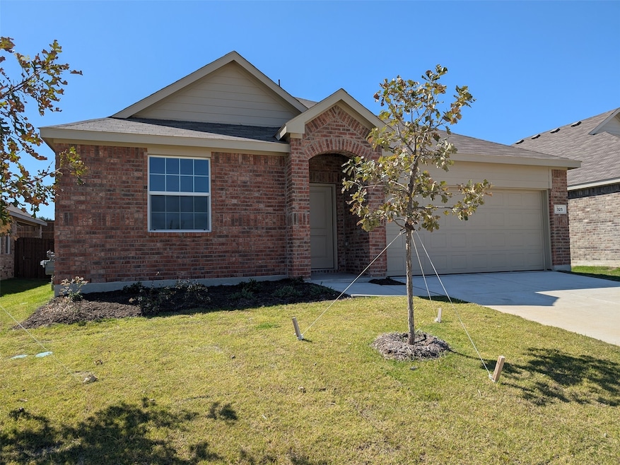 Ranch-style house featuring concrete driveway, a front lawn, an attached garage, brick siding, and a shingled roof