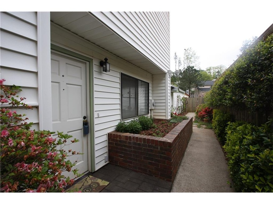 Wood gate opens to private courtyard/garden area s