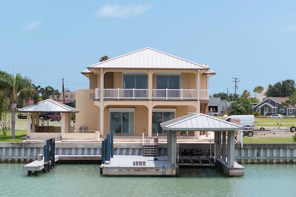 Dock featuring a balcony, a gazebo, and a water v