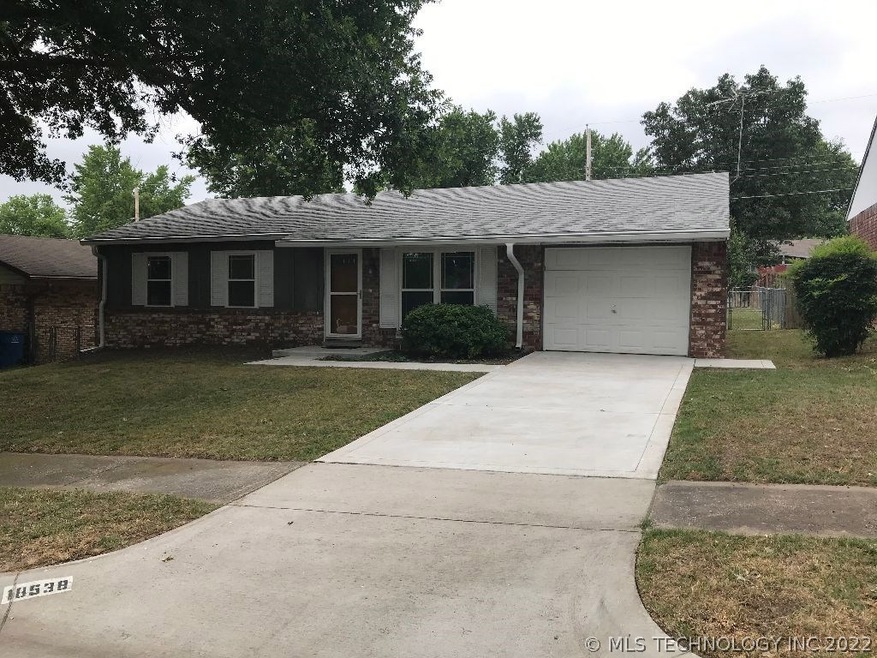 Striking brick home with full glass entry door and