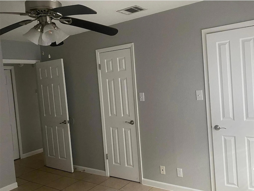 Unfurnished bedroom featuring light tile patterne