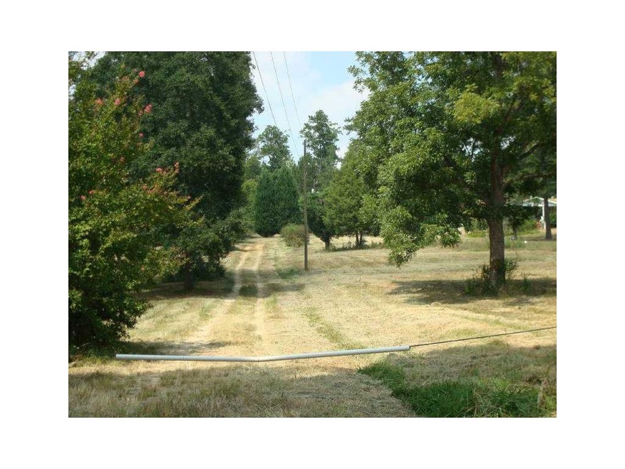 Exterior Front. Long driveway to a hilltop setting