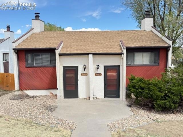 View of front of property featuring a chimney and 