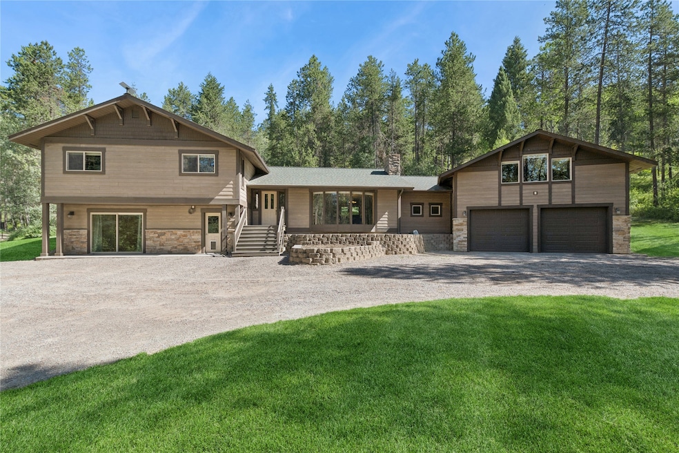 A large gravel driveway leads to this lovely country home