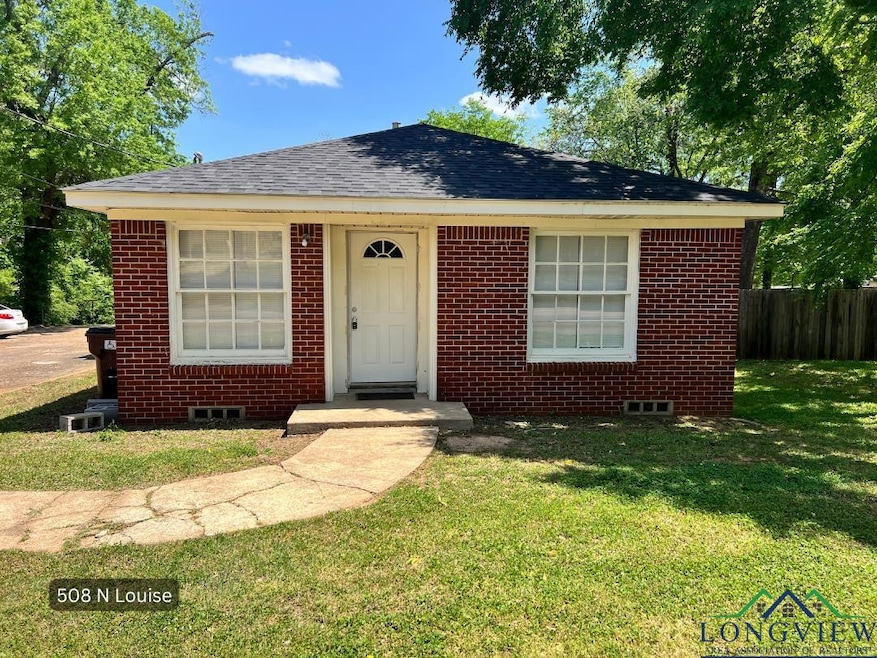 Bungalow featuring brick siding and roof with shingles